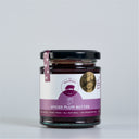 A glass jar of Mulberry Pig Spiced Plum Butter with a black lid, featuring a white and purple label with a Sydney royal 'Gold medal 2024', set against a plain light gray background.