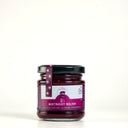 A picnic size glass jar of Beetroot Relish from The Mulberry Pig with a black lid and a purple label, set against a plain white background.