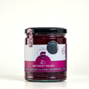 A glass jar of Beetroot Relish by The Mulberry Pig, featuring a black lid and a white and magenta label, set against a plain white background.