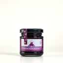 A glass jar of Spiced Plum Butter by The Mulberry Pig, featuring a black lid and a purple and white label, set against a plain light gray background.