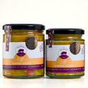 Two glass jars of The Mulberry Pig Summer Relish with black lids and white, orange, and purple labels, set against a clean white background.