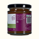 Jar of butter with a purple label on a white background
