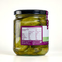 A glass jar of the mulberry pig bread and butter pickled cucumbers with a black lid, showing the back of the label with nutrition information. The jar is set against a clean, light gray background.