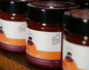 Jars of The Mulberry Pig Sweet Chilli Jam on a wooden shelf