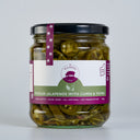 A glass jar of The Mulberry Pig Pickled Jalapeños with a black lid and a white, dark green, and purple label, set against a plain light grey background.