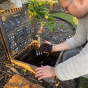 Owner and Chef Dom checking compost made with food waste from the Mulberry Pig