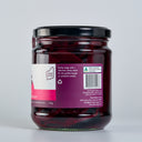 A glass jar of The Mulberry Pig Pickled Beetroot with a black lid and a white, pink, and purple label with product description, set against a plain light gray background.