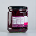 A glass jar of The Mulberry Pig Pickled Beetroot with a black lid and a white, pink, and purple label showing nutrition label, set against a plain light gray background.
