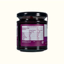 Jar of jam with a purple label showing nutrition information on a white background