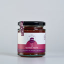 A glass jar of 'The Mulberry Pig' Quince Paste on a light gray background. The jar contains deep red quince paste, has a black lid, and a white and magenta label with a purple ribbon seal.