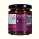 Jar of quince paste with a purple label on a white background