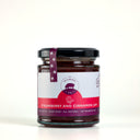 A glass jar of Mulberry Pig Strawberry and Cinnamon Jam with a black lid and a white and red label, set against a plain white background.