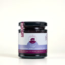 A jar of the mulberry pig blueberry and lavender jam, showing the front label with purple branding and light blue product stripe.