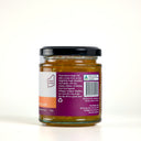 Back of a jar of The Mulberry Pig Orange & Whiskey Marmalade showing the product description and barcode, on a plain light background.