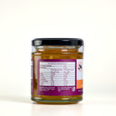 Back of a jar of The Mulberry Pig Orange & Whiskey Marmalade showing the nutrition information panel and ingredients, on a plain light background.