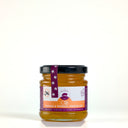 A 100g picnic jar of The Mulberry Pig Orange & Whiskey Marmalade with a black lid and purple seal ribbon, on a plain light background.
