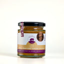 A glass jar of Mulberry Pig Apple, Pear and Ginger Chutney with a black lid and a white, gold, and purple label, set against a plain white background.