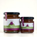 Two glass jars of The Mulberry Pig Apple & Thyme Butter, one large and one small, with black lids and white and green labels, set against a light gray background.
