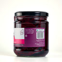 A glass jar of The Mulberry Pig Pickled Beetroot with a black lid and a white, pink, and purple label with product description, set against a plain light gray background.
