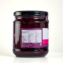 A glass jar of The Mulberry Pig Pickled Beetroot with a black lid and a white, pink, and purple label showing nutrition label, set against a plain light gray background.