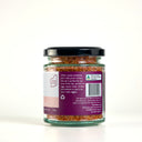 A glass jar of The Mulberry Pig Smoked Chilli Garlic Salt with a black lid and a white and pink label, set against a plain white background.