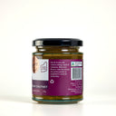 A glass jar of The Mulberry Pig Eggplant, Sultana & Curry Leaf Chutney with a black lid and a purple and white label with the product description, set against a plain white background.