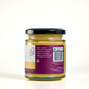 A glass jar of the mulberry pig lemon curd with a black lid and a purple label showing product information, photographed on a clean white background.