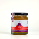 A glass jar of 'The Mulberry Pig' Blood Orange and Ginger Marmalade with a black lid and a white, red, and purple label, set against a plain light gray background.