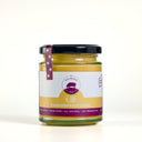 A glass jar of 'The Mulberry Pig' Passionfruit Curd with a black lid and a white and gold label, set against a plain white background.