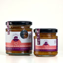 Two glass jars of The Mulberry Pig Peach Chilli and Black Pepper Chutney on a clean white background, with one large jar and one smaller jar side by side.