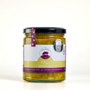 A glass jar of 'The Mulberry Pig' Piccalilli small batch hand-made pickles, featuring a white and gold label with purple accents and a black lid, set against a plain white background.