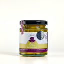 A glass jar of Piccalilli by The Mulberry Pig, featuring a black lid and a white, yellow, and purple label, set against a plain white background.