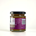 A glass jar of The Mulberry Pig smoked onion Marmalade, with a black lid, showing the back label with a purple background, barcode, and product details on a white background.