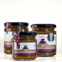 Three glass jars of Mulberry Pig Smoked Onion Marmalade arranged on a white surface against a white background, with the front jar slightly overlapping the others.