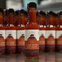 a bottle of the mulberry pig slow smoke hot sauce